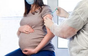 Pregnant,Vaccination.,Pregnant,Woman,In,Face,Mask,Getting,Vaccinated,In